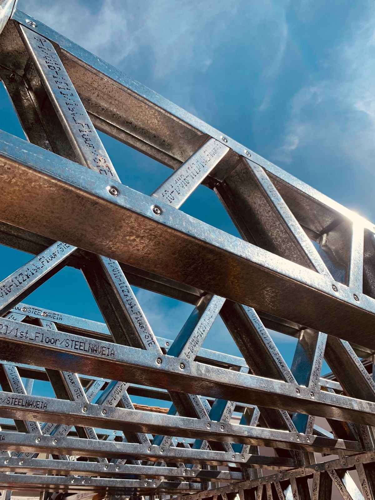 Estrutura em light steel frame montada, vista de baixo contra o céu